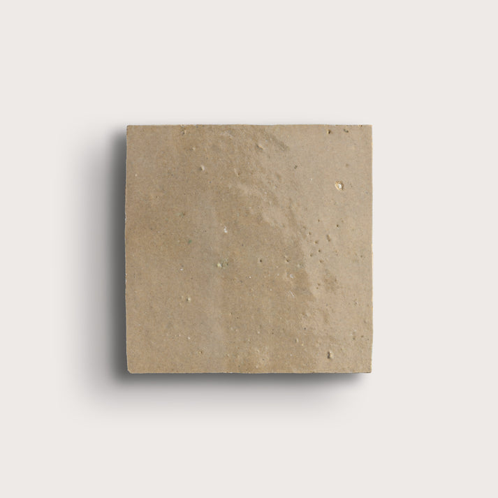 Square beige zellige tile on a light gray background
