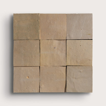 Nine square zellige tiles in various shades of brown on a white background