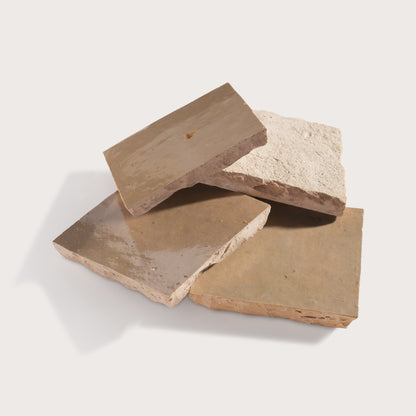 Four pieces of zellige tile on a white background