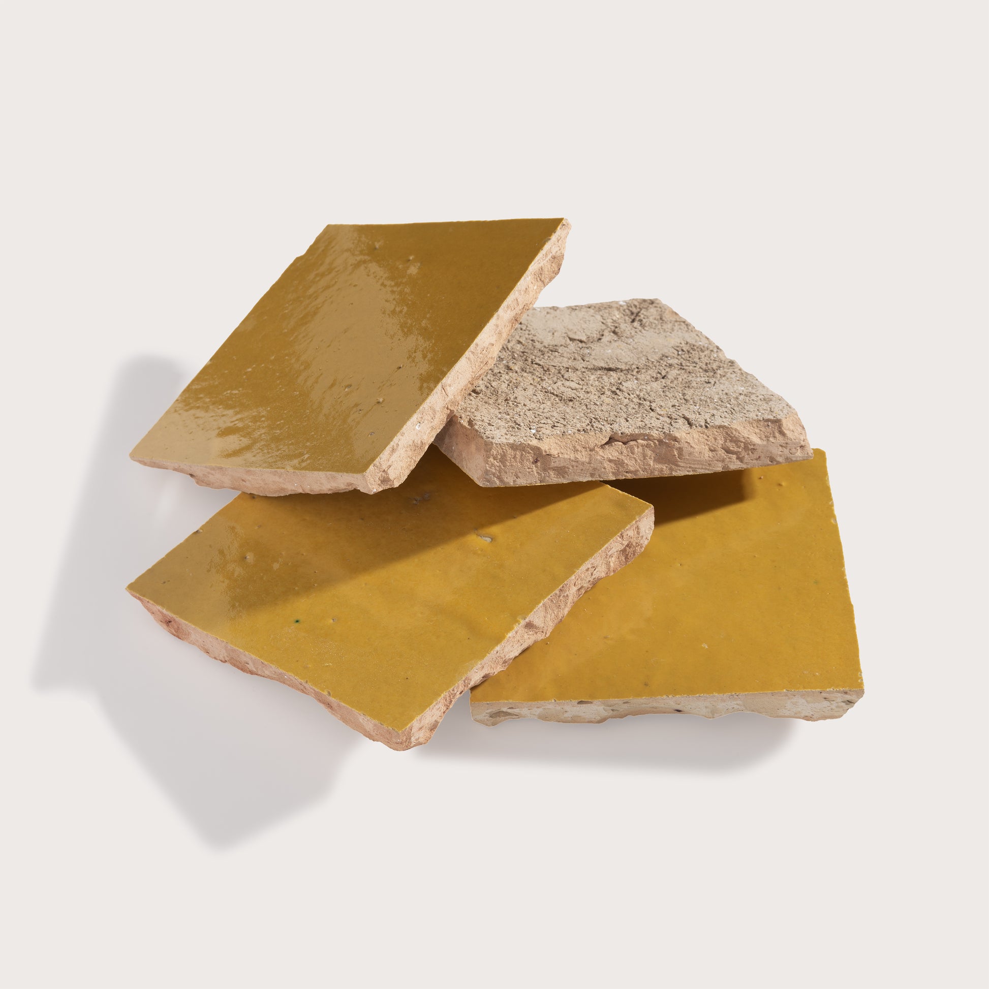 Three zellige tiles with different textures on a white background