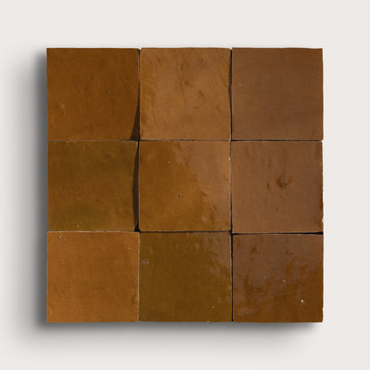 brown square zellige tile on light gray background