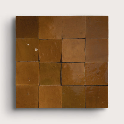 brown square zellige tile on light gray background