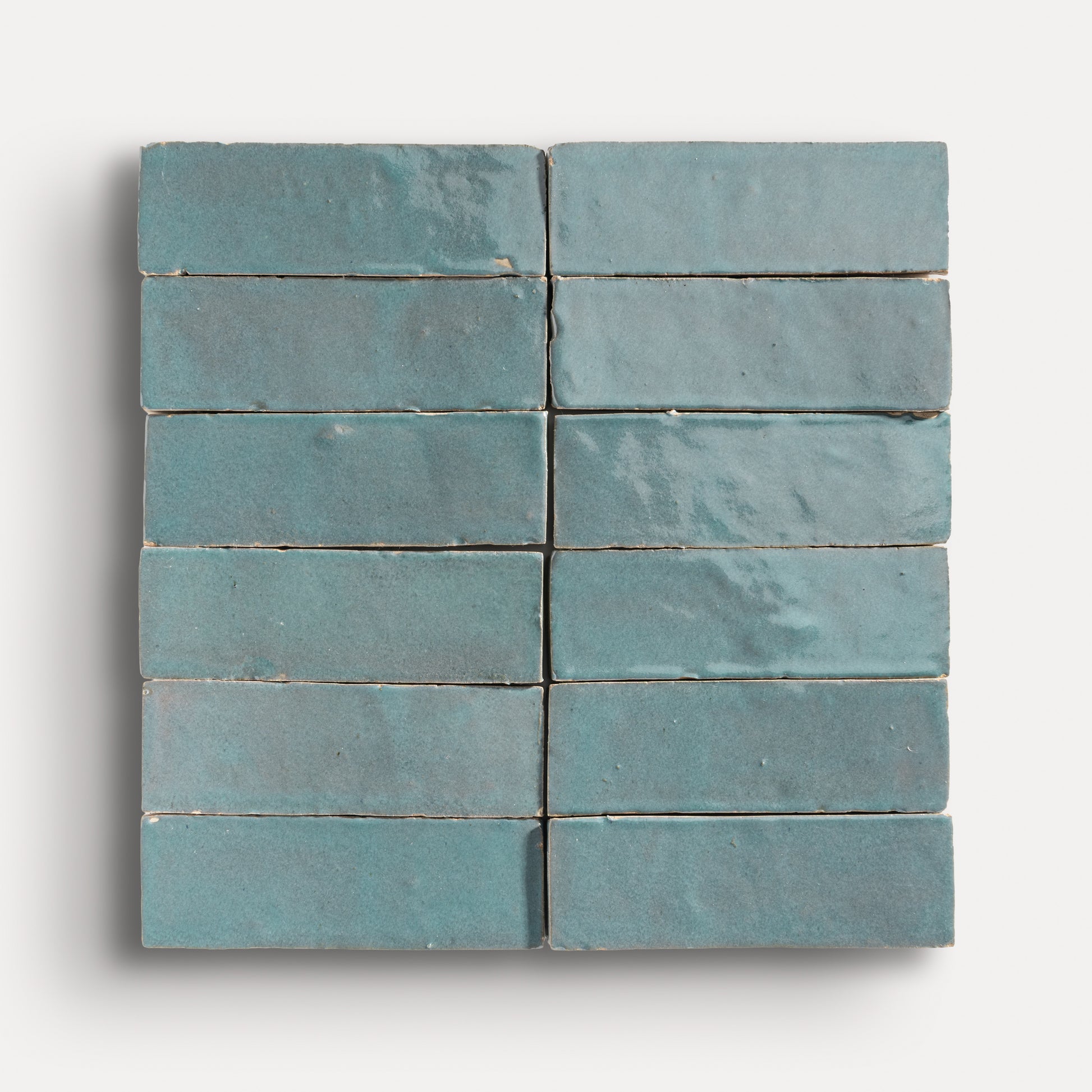 twelve blue tiles arranged in grid on a white background