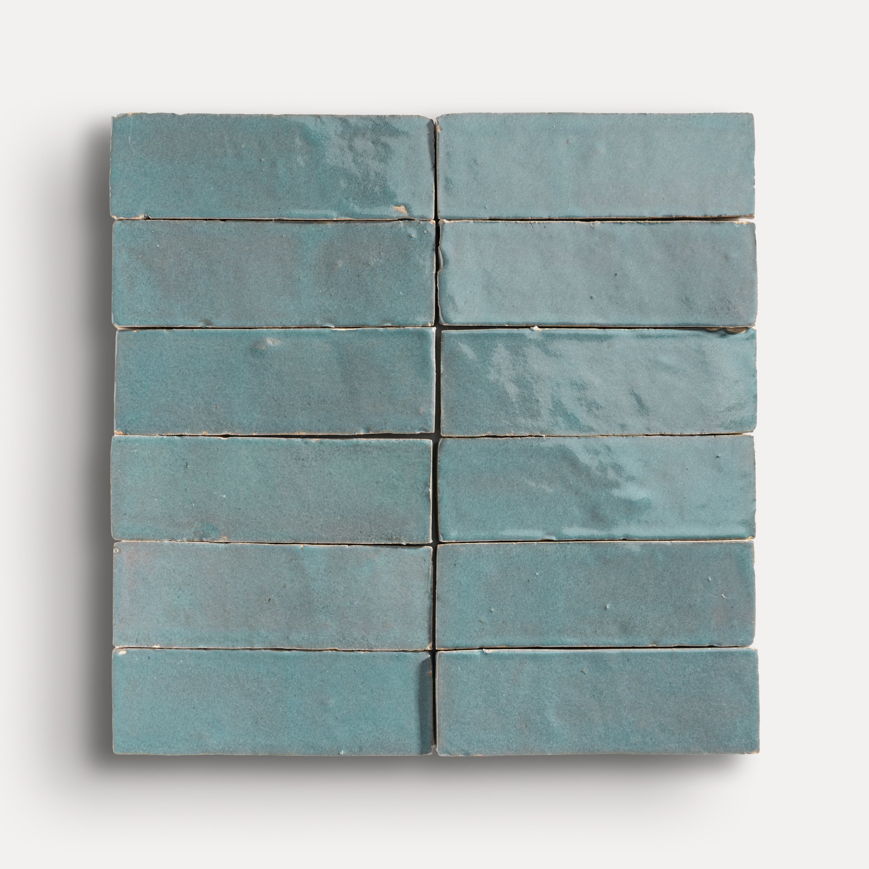 twelve blue tiles arranged in grid on a white background