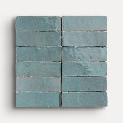 twelve blue tiles arranged in grid on a white background