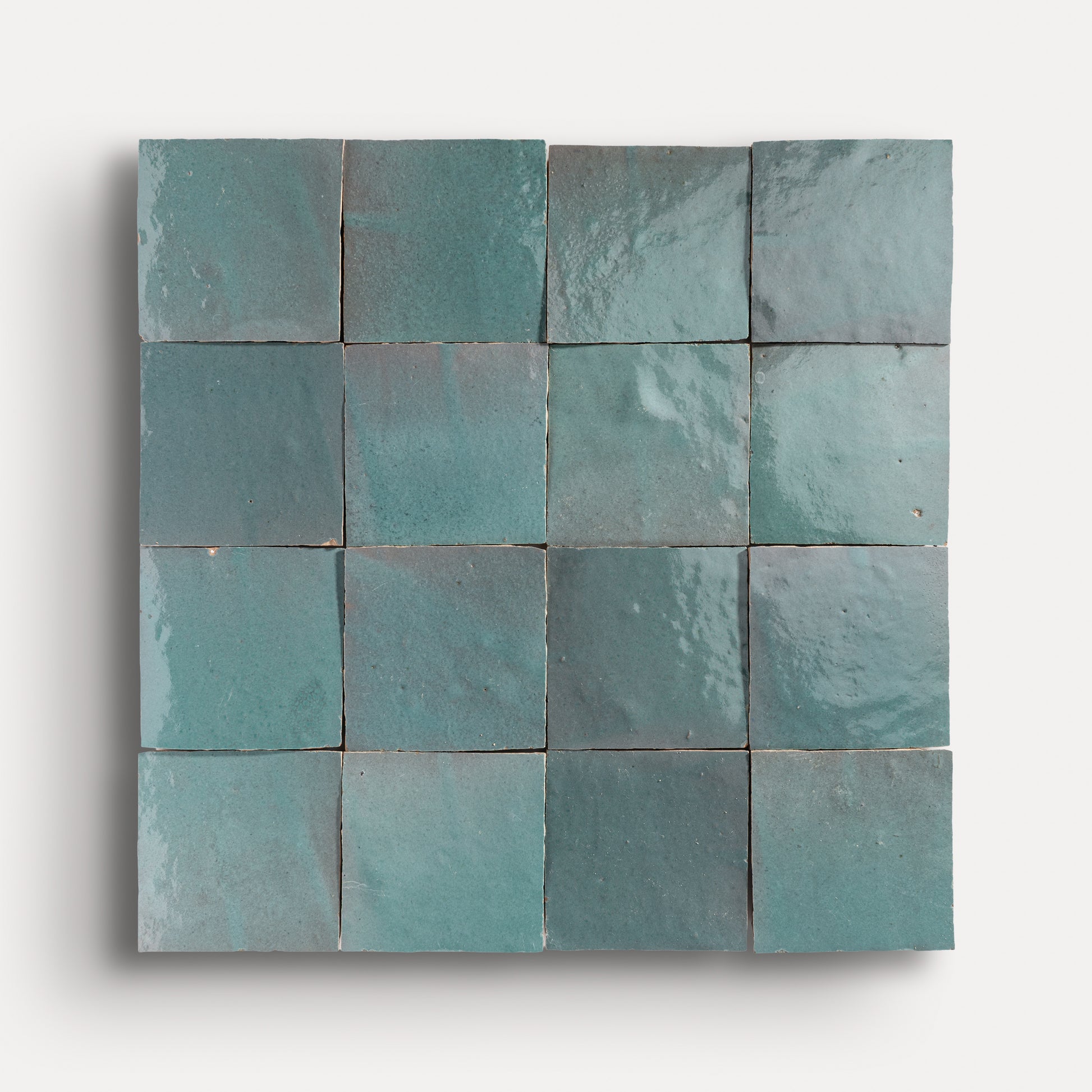 Square zellige tiles with a blue-green gradient on a white background