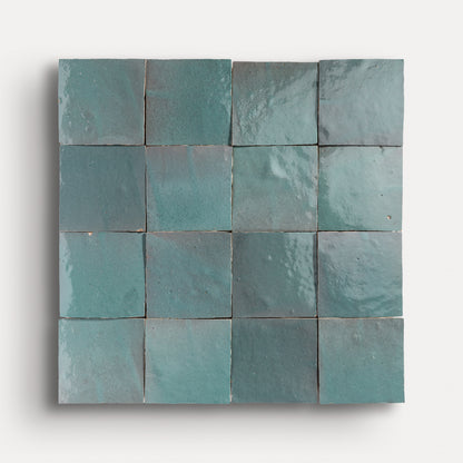 Square zellige tiles with a blue-green gradient on a white background
