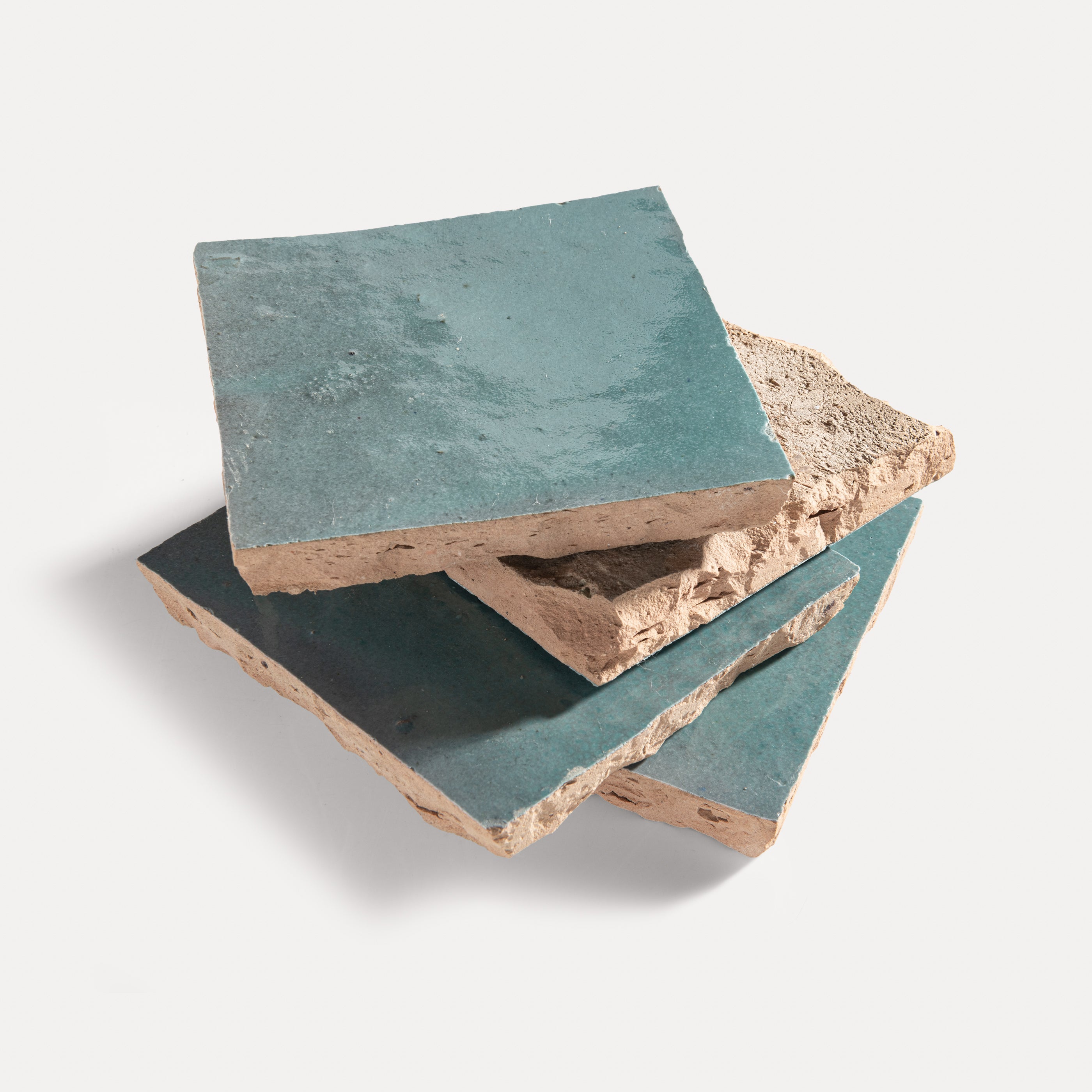 zellige tiles with a greenish-blue surface on a light gray background