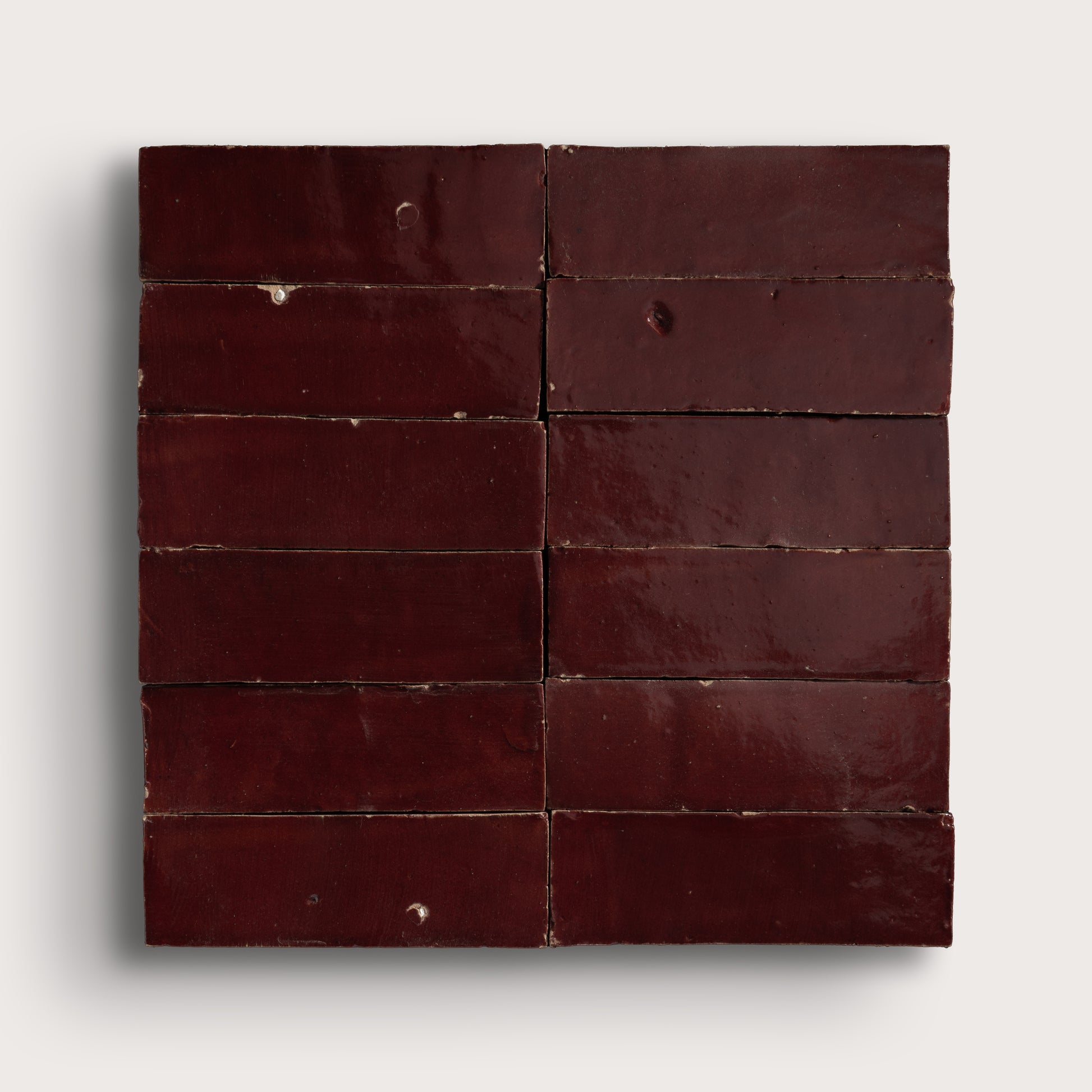 red rectangle zellige tile in a grid on light gray background