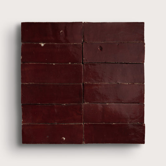 red rectangle zellige tile in a grid on light gray background