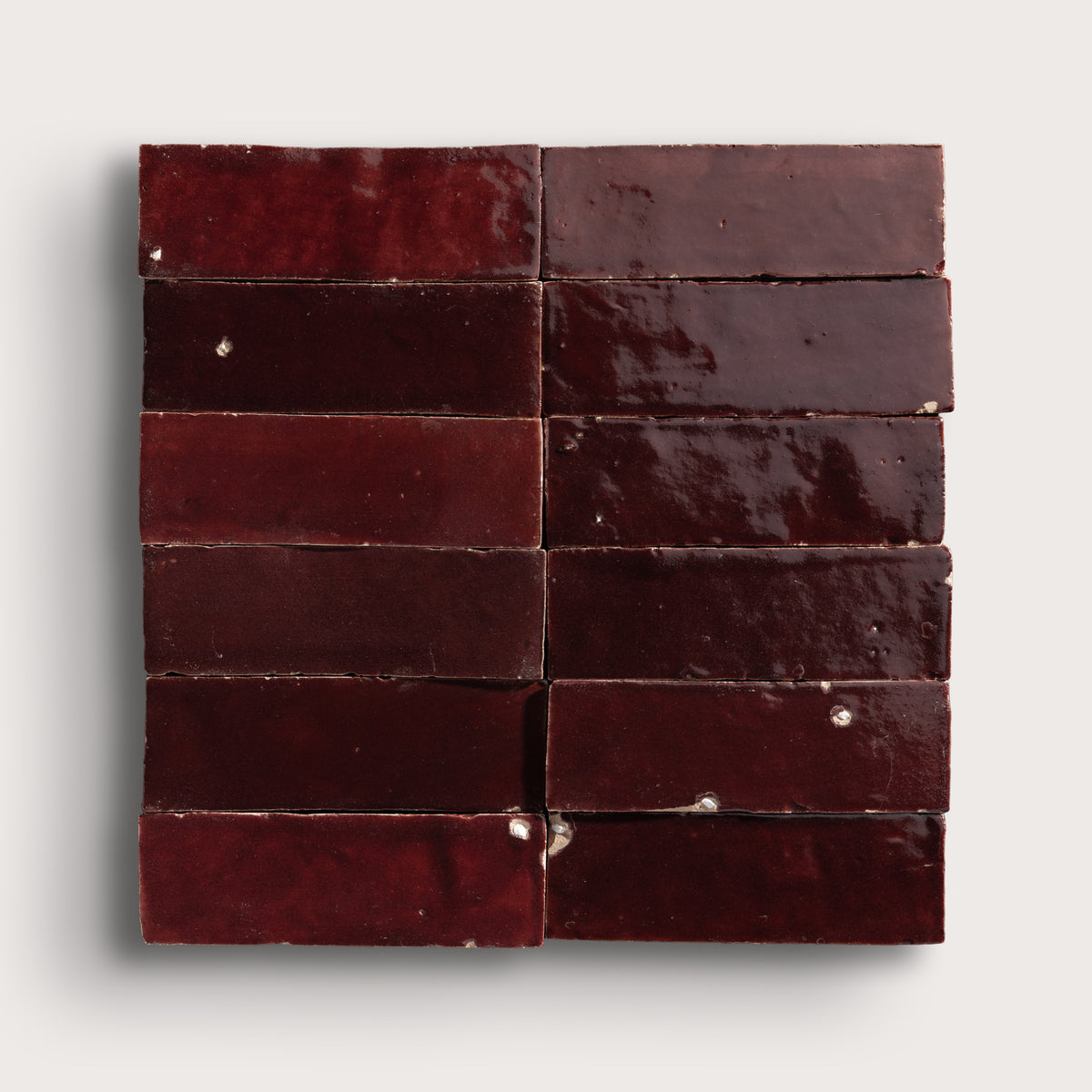 red rectangle zellige tile in a grid on light gray background
