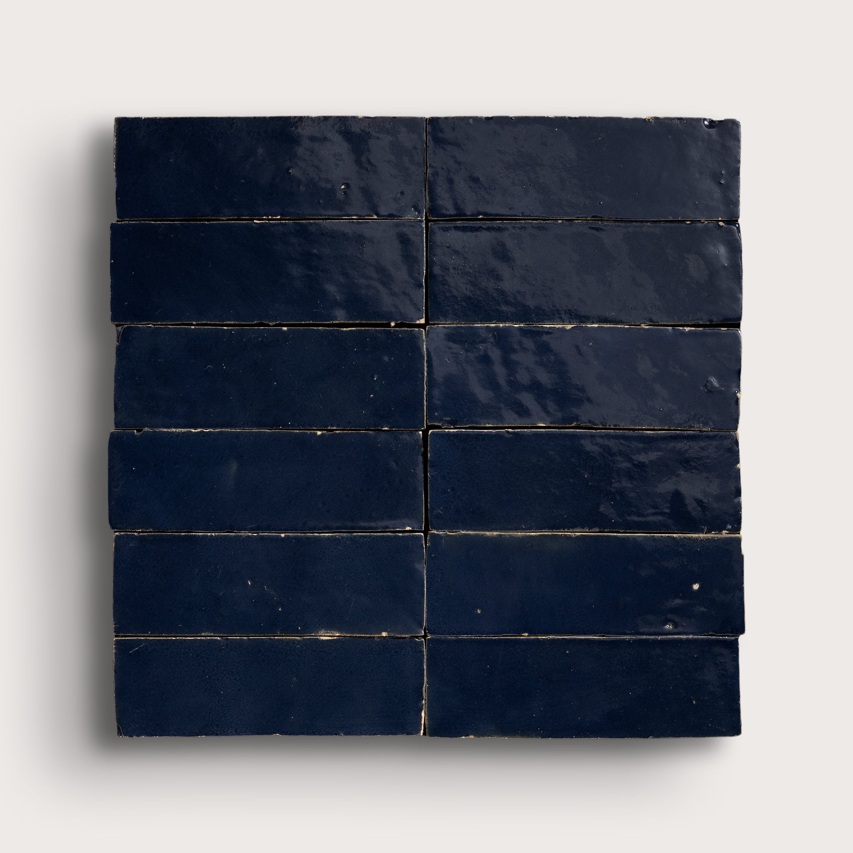 Navy blue zellige tiles arranged in a grid pattern on a white background