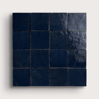 Square zellige tile with dark blue tiles on a light gray background