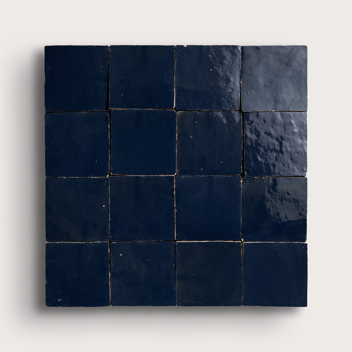 Square zellige tile with dark blue tiles on a light gray background