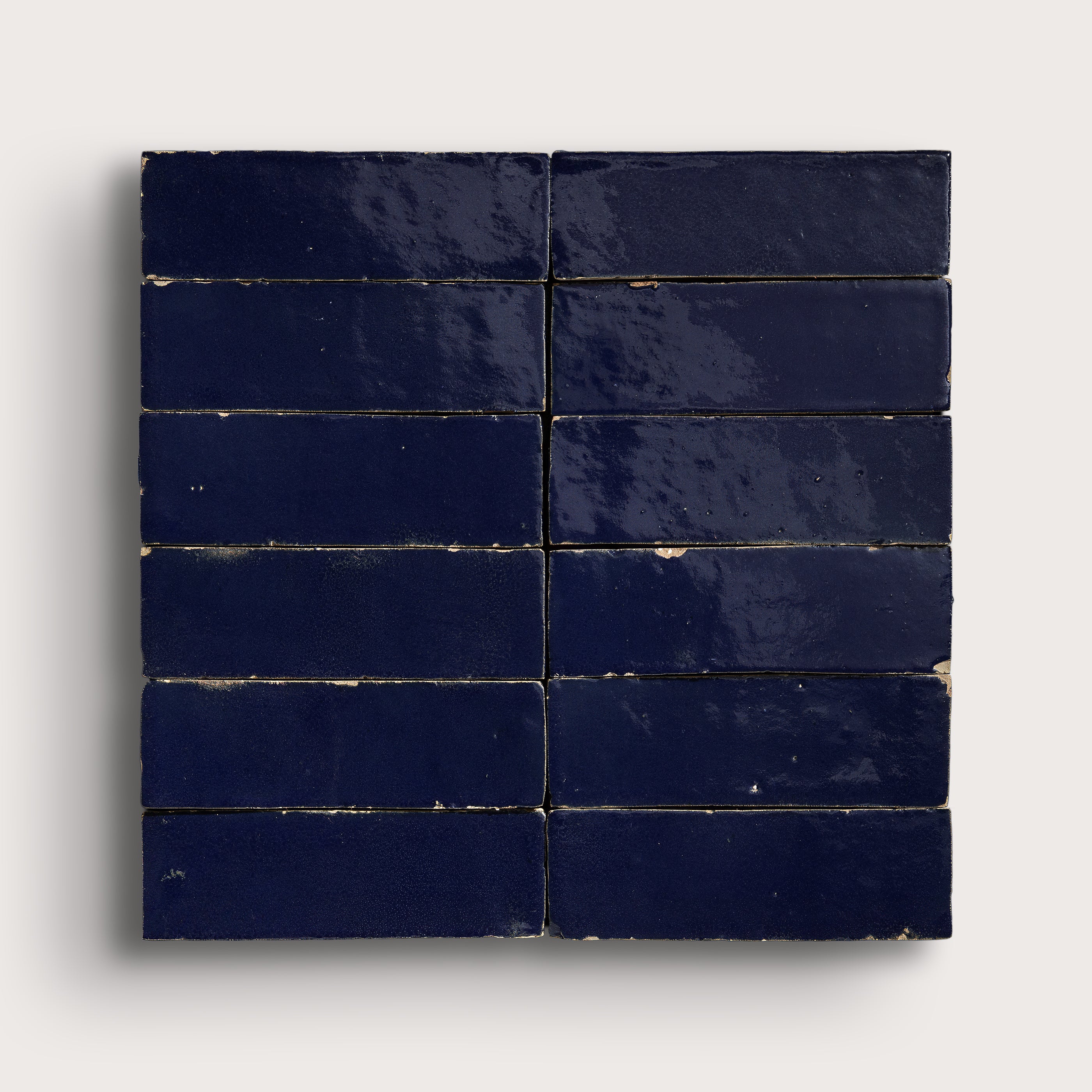 Navy blue zellige tiles arranged in a grid pattern on a white background