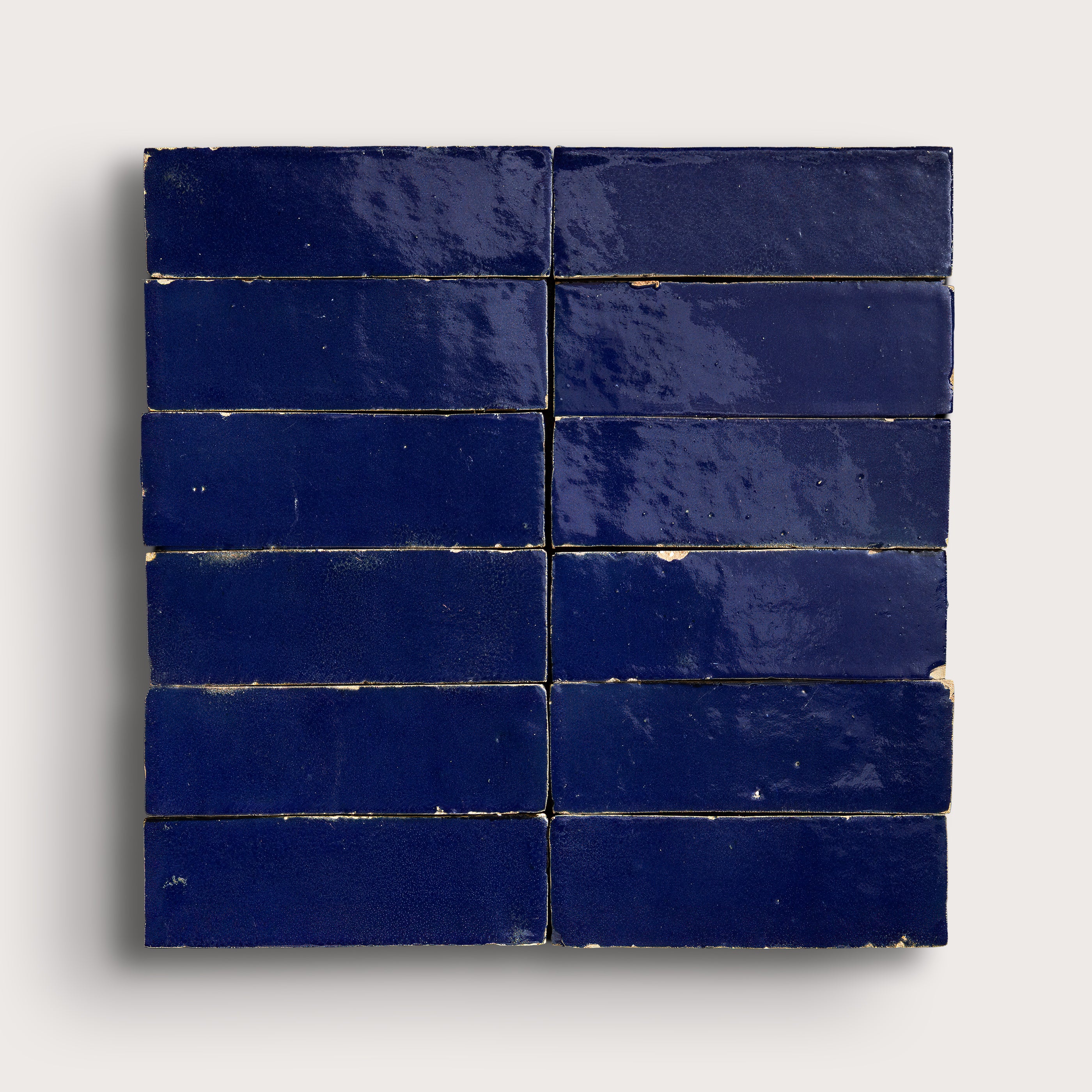 rectangle blue zellige tiles arranged in a grid on light grey background