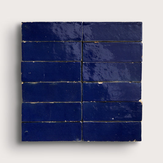 rectangle blue zellige tiles arranged in a grid on light grey background