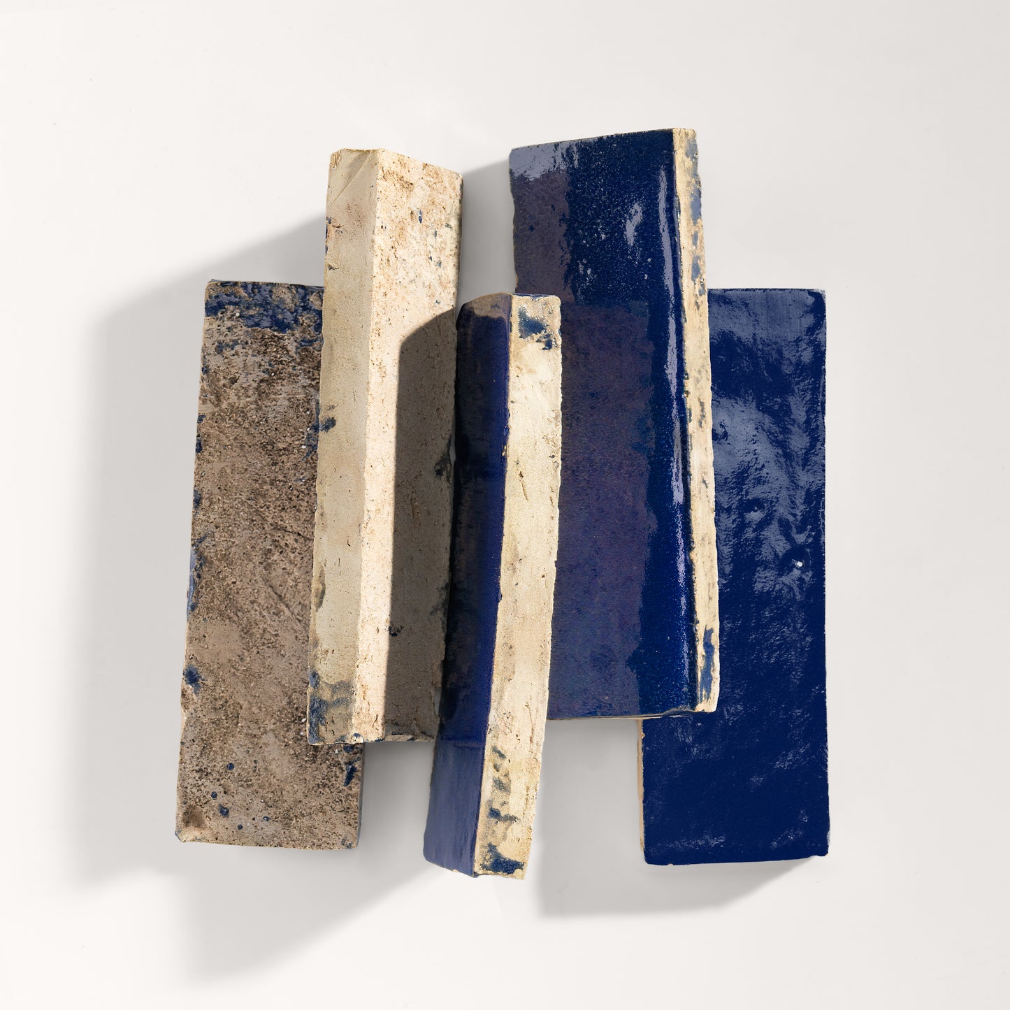 stack of blue rectangle zellige tile on light grey background
