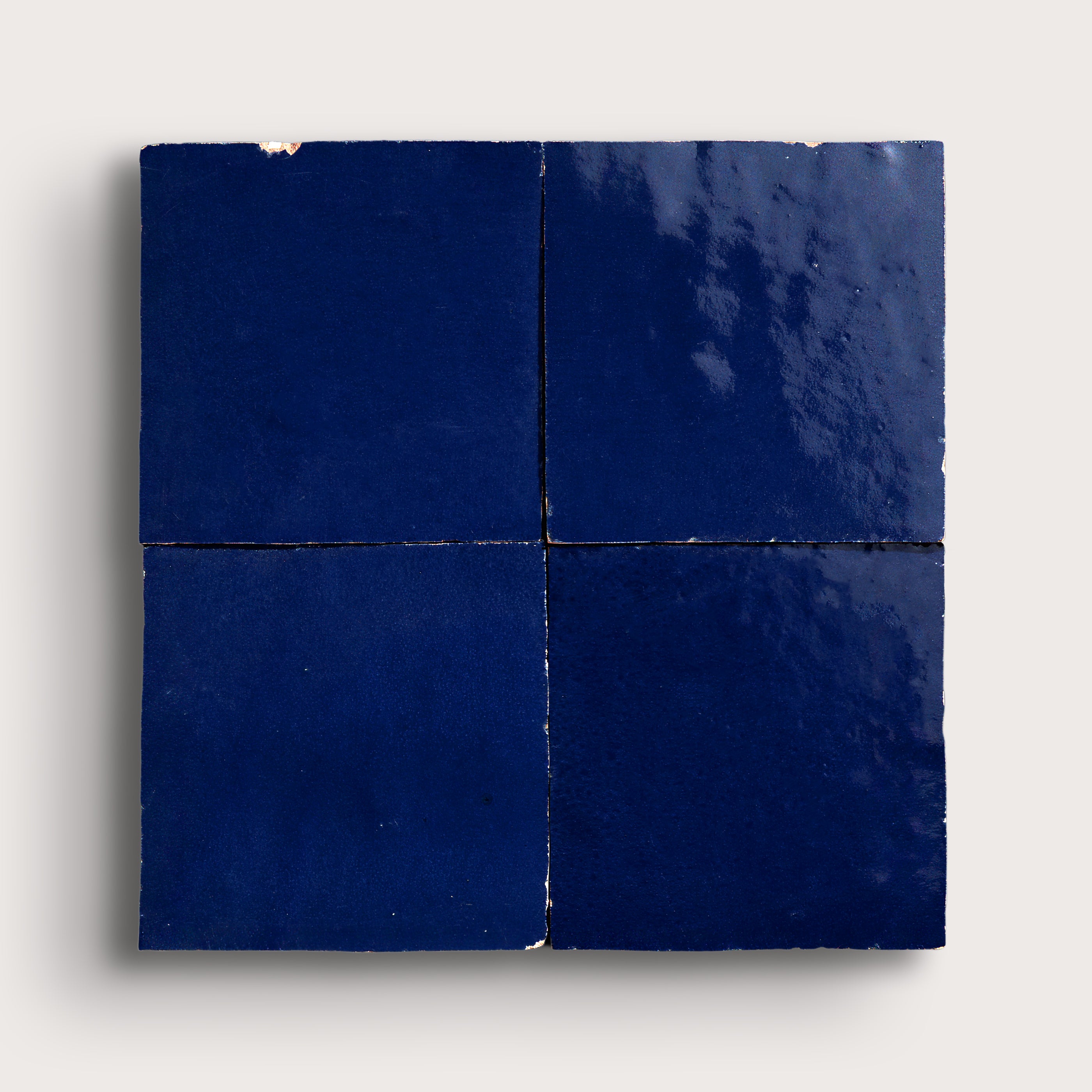 blue square zellige tile in grid pattern on light grey background