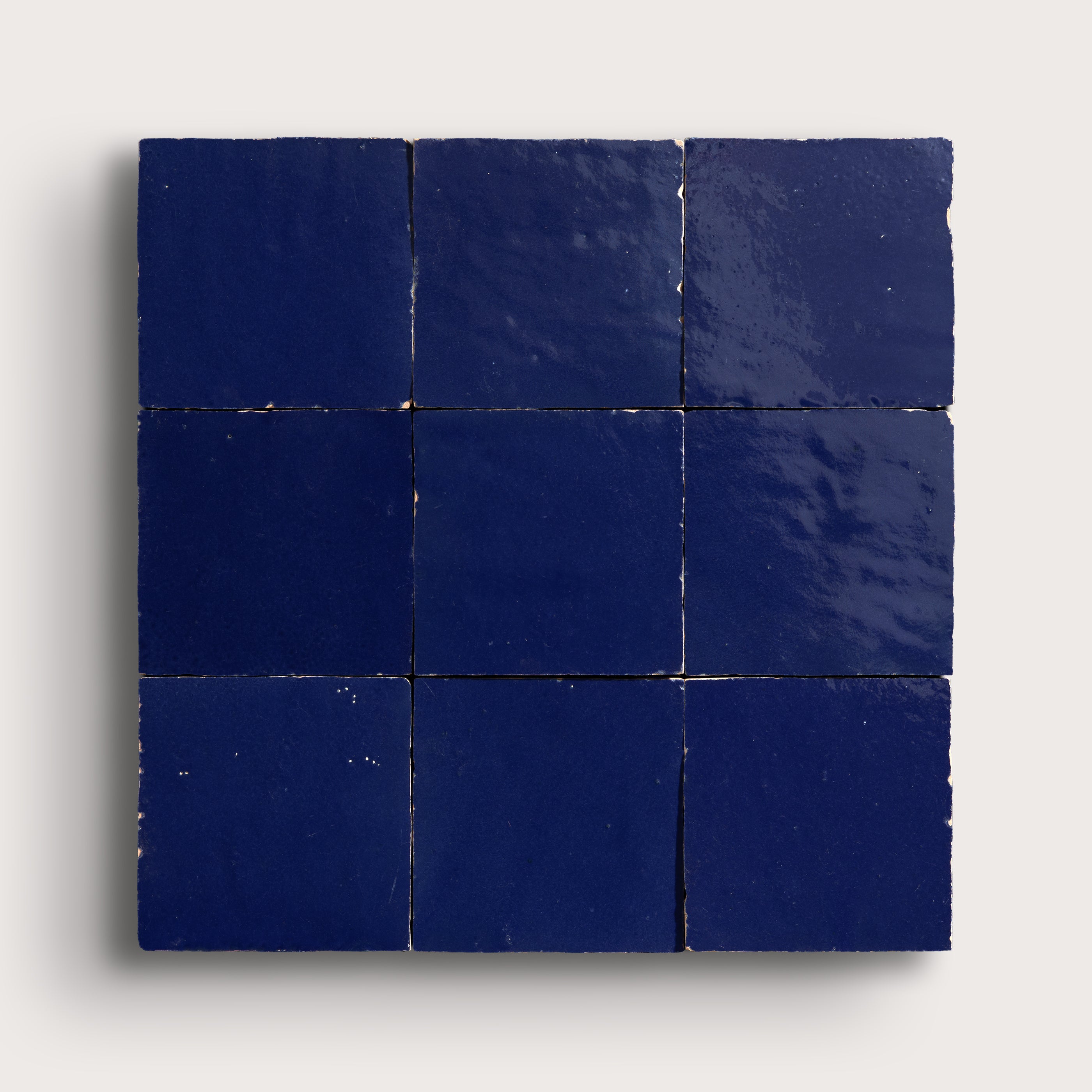 blue square zellige tile in grid pattern on light grey background