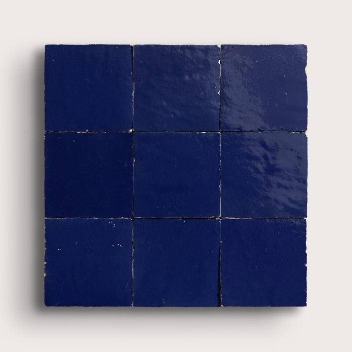 blue square zellige tile in grid pattern on light grey background