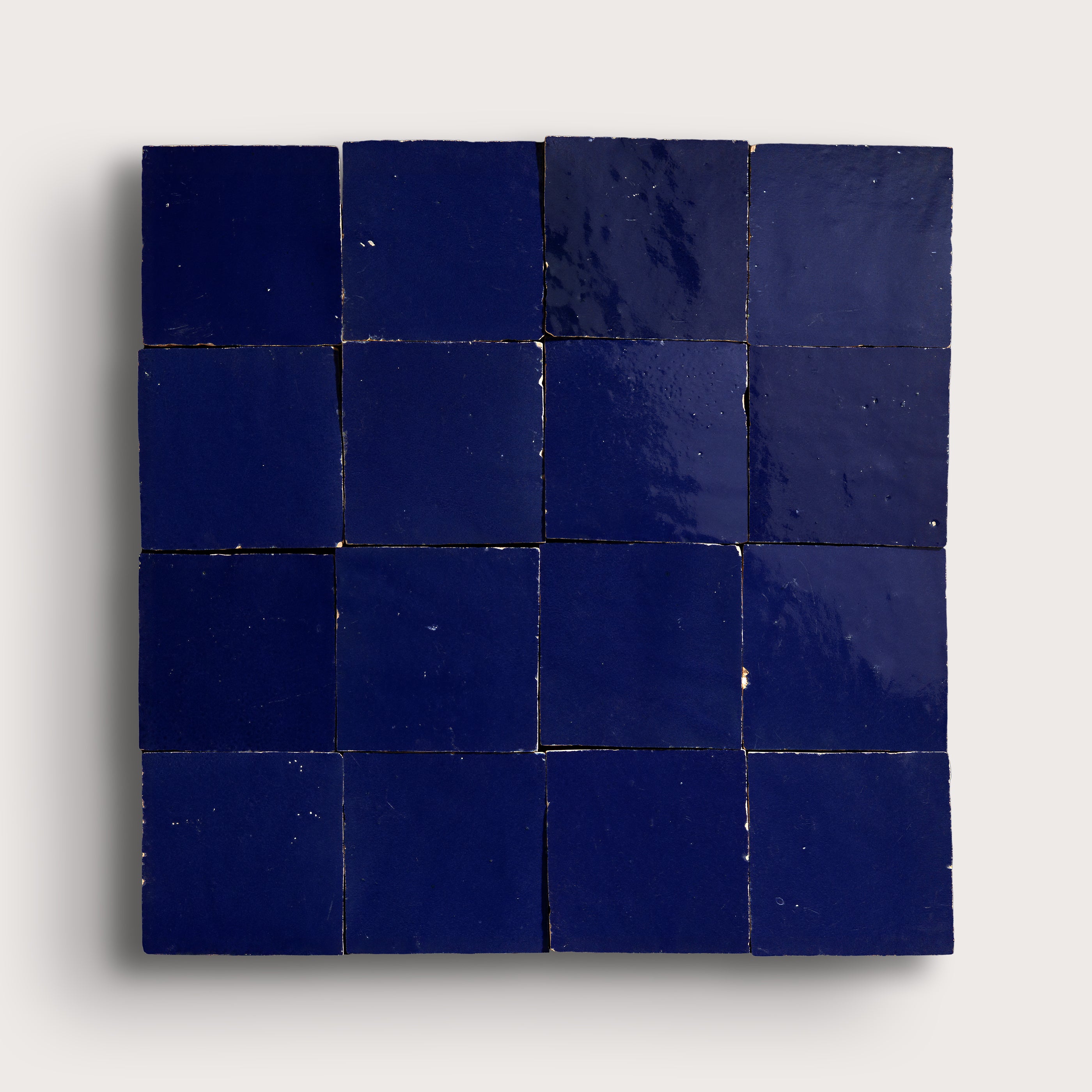 blue square zellige tile in grid pattern on light grey background