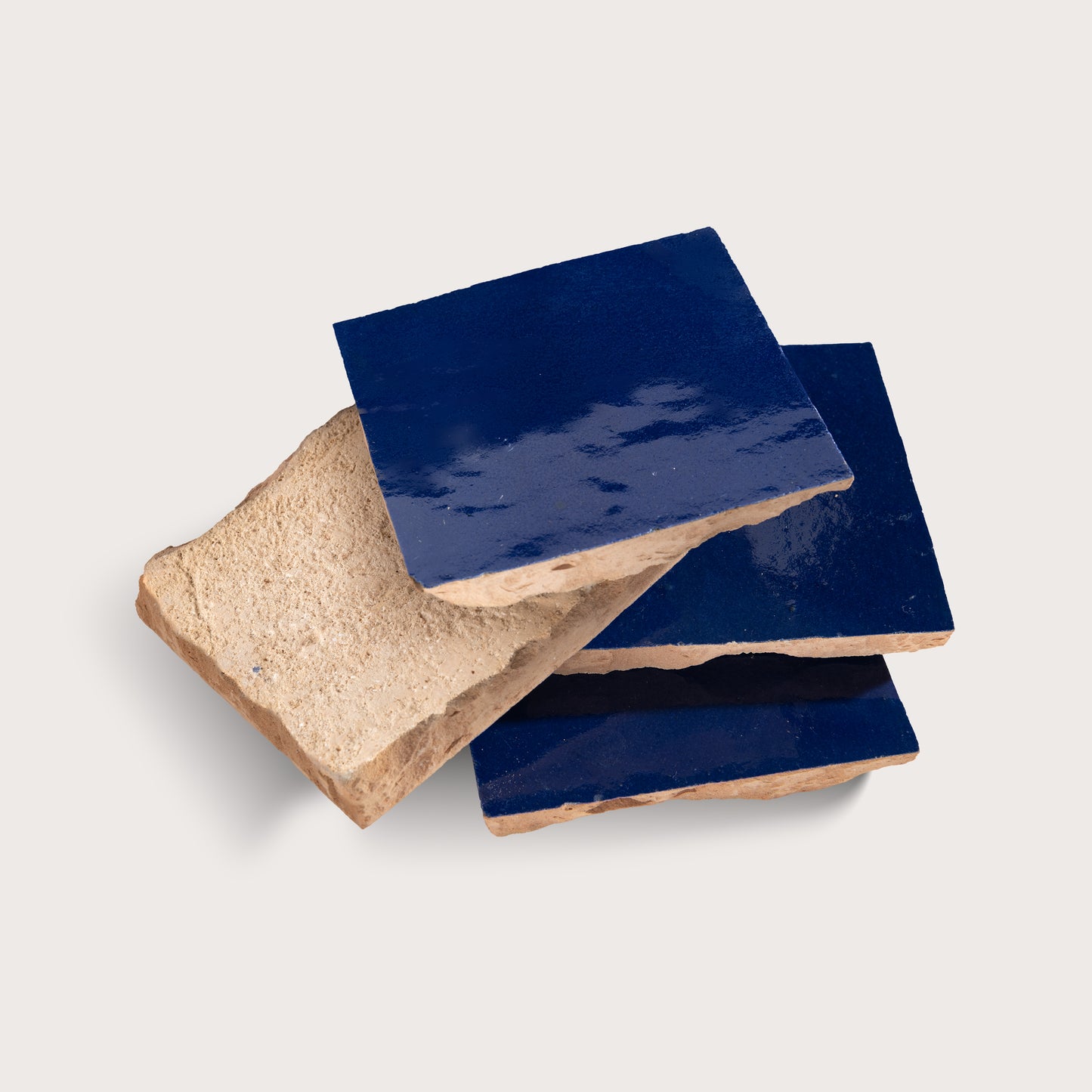 stack of blue square zellige tile on light grey background