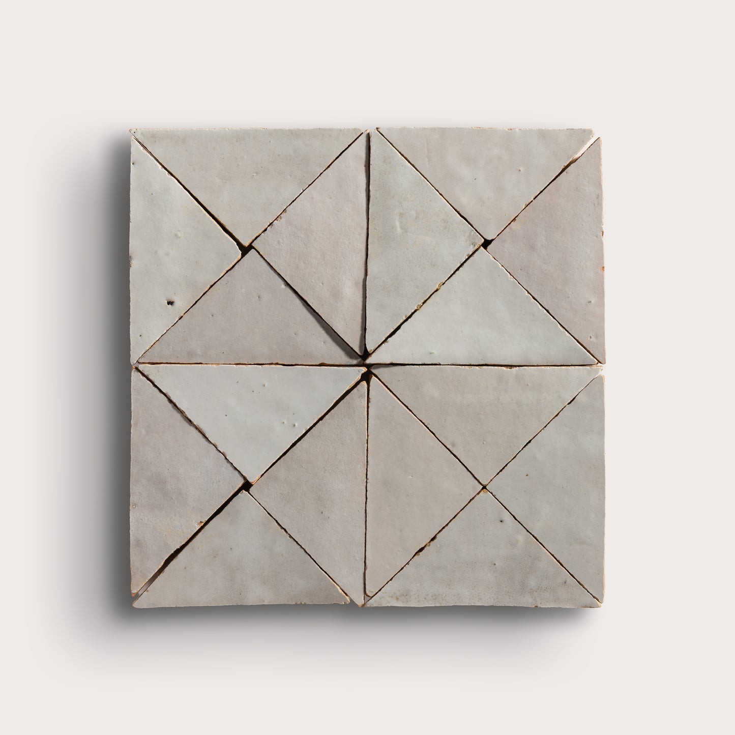 natural white mosaic triangle zellige tile on a light grey background