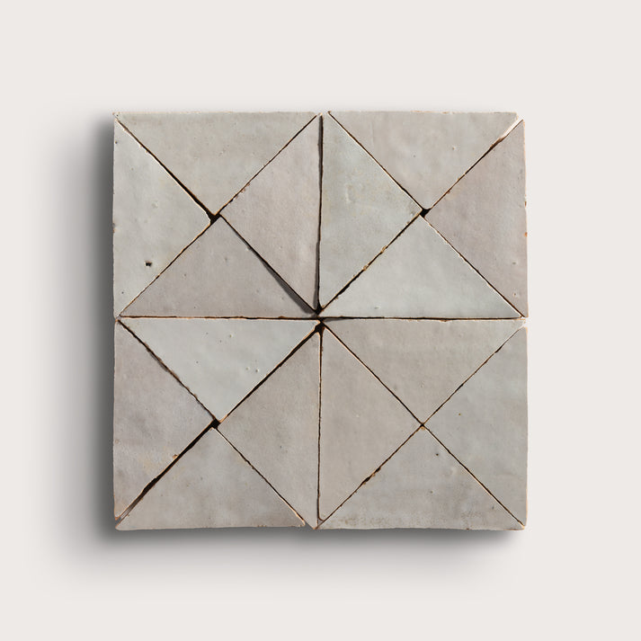 natural white mosaic triangle zellige tile on a light grey background