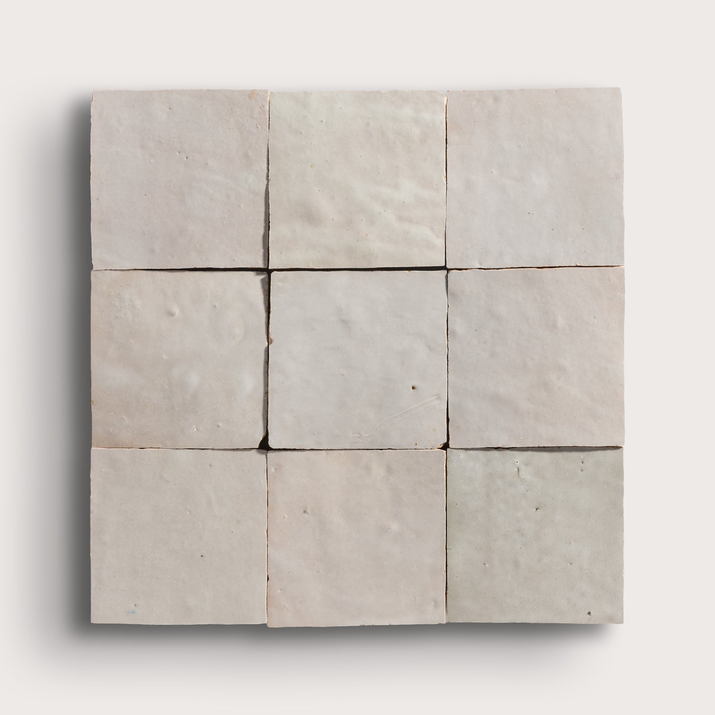 natural white square zellige tile arranged in grid on light grey background