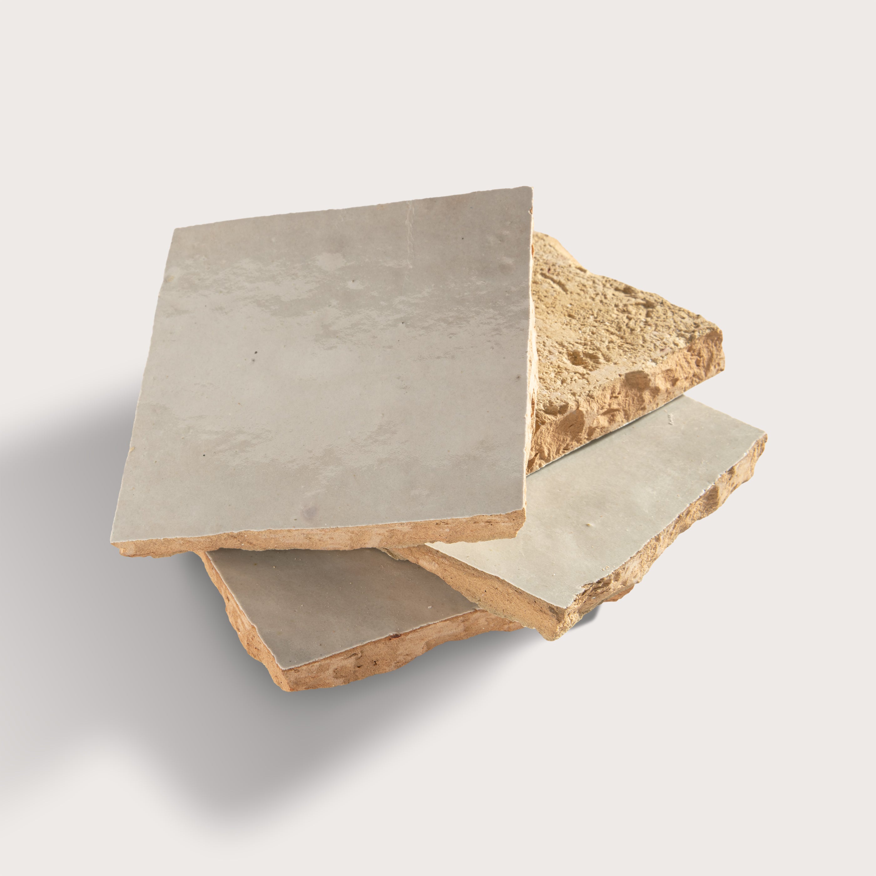 natural white square zellige tile arranged in a stack on light grey background