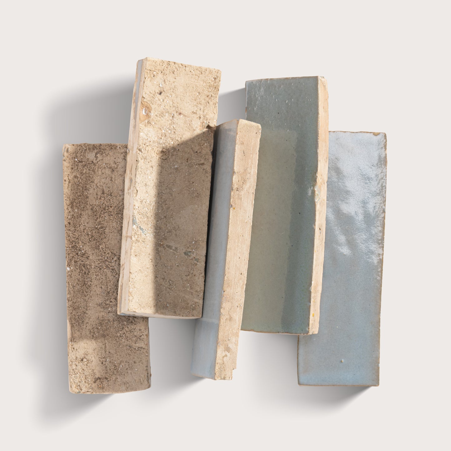 Five rectangular stone samples with different textures and colors on a light gray background