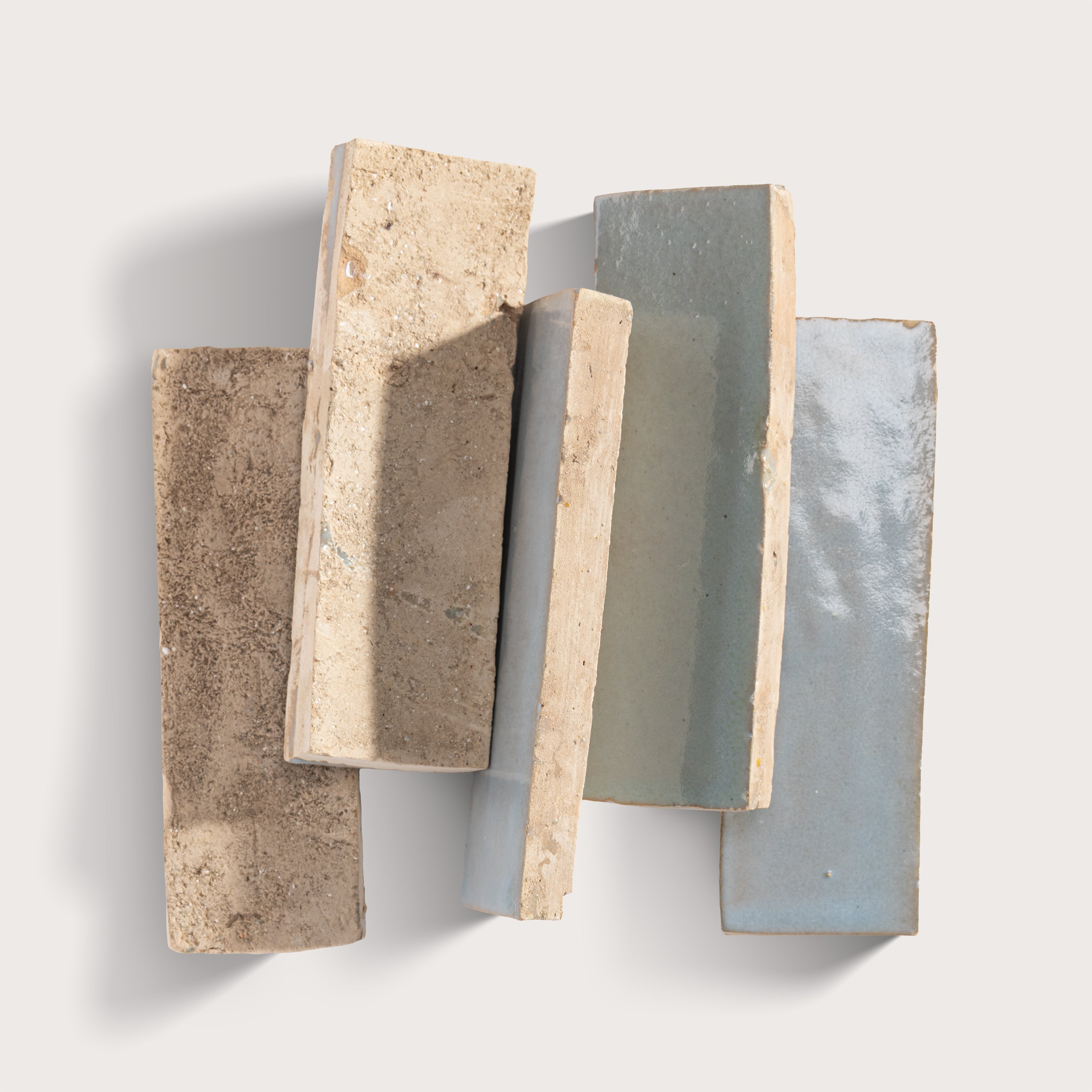 Five rectangular stone samples with different textures and colors on a light gray background