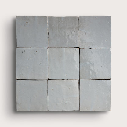Nine square zellige stone tiles arranged in a 3x3 grid on a white background