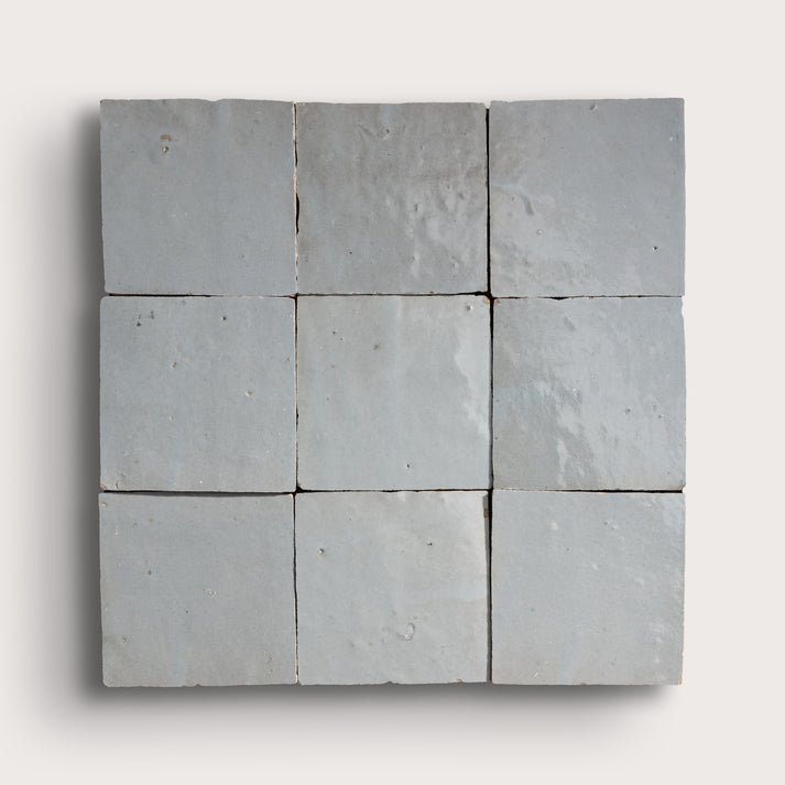 Nine square zellige stone tiles arranged in a 3x3 grid on a white background
