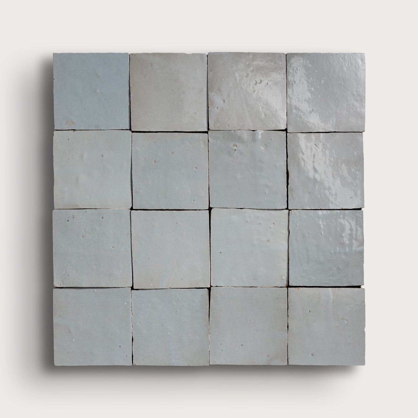 Grid of square tiles in various shades of gray on a white background