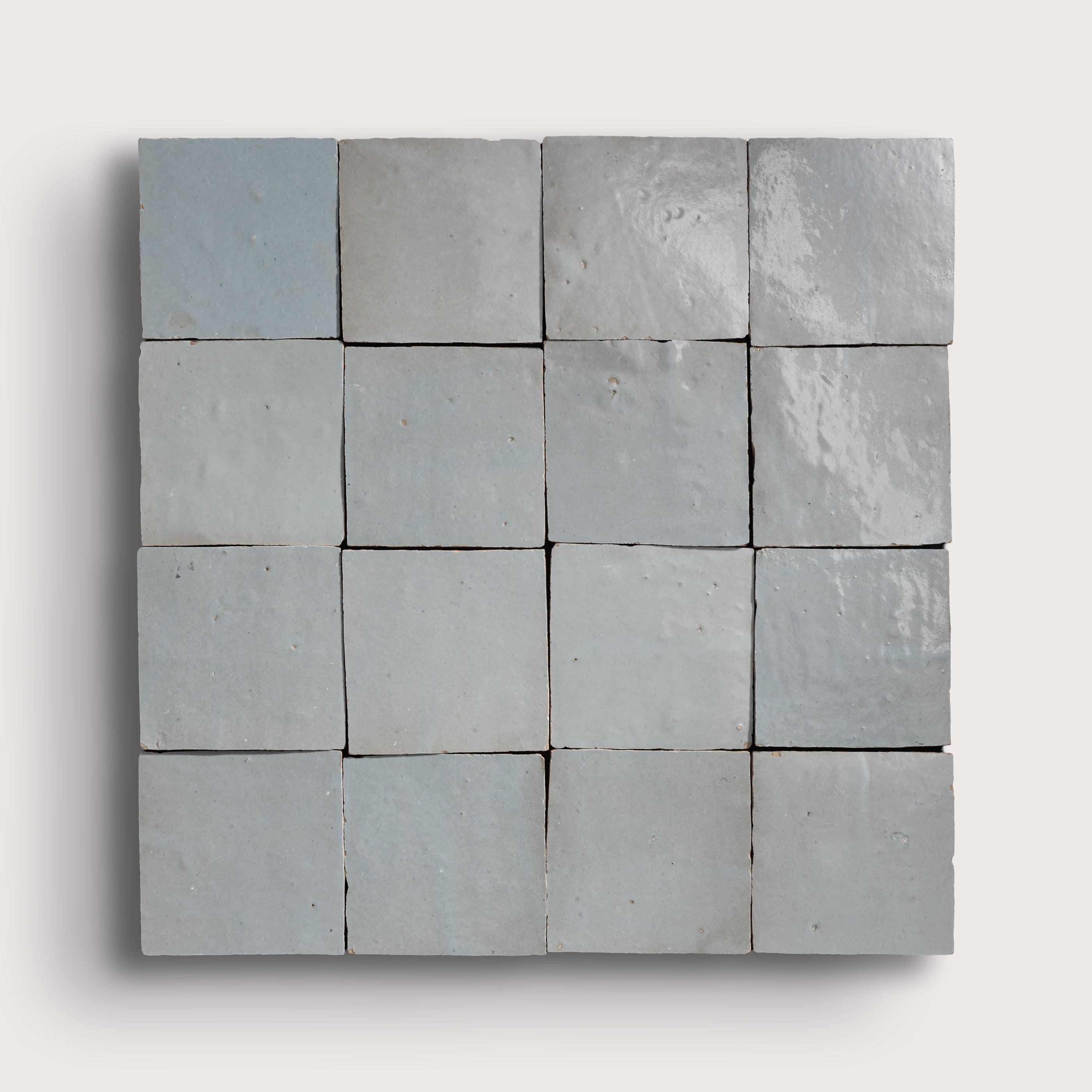 Grid of square tiles in various shades of gray on a white background