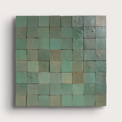 Zellige Square tile mosaic with green and blue hues on a white background