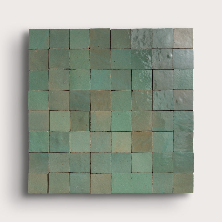Zellige Square tile mosaic with green and blue hues on a white background