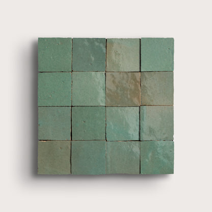 Square arrangement of green zellige tiles on a light gray background