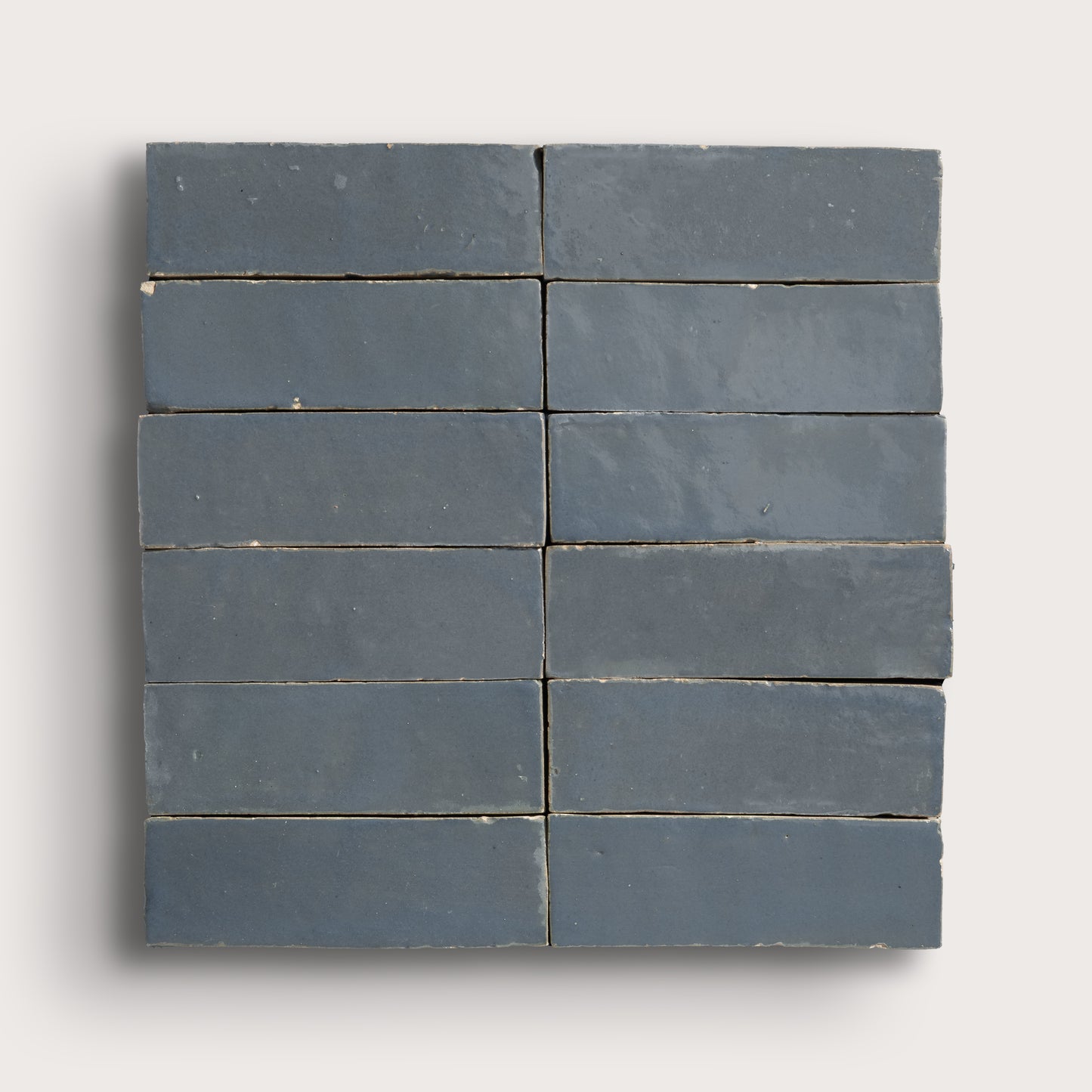 twelve blue rectangular tiles on a light gray background