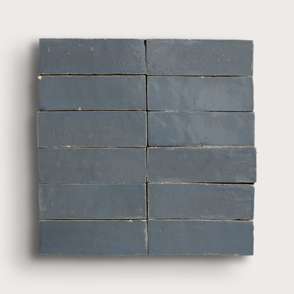 twelve blue rectangular tiles on a light gray background