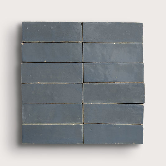 twelve blue rectangular tiles on a light gray background