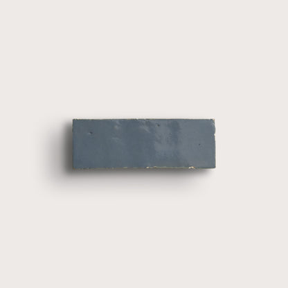 blue rectangular zellige tile on a light gray background