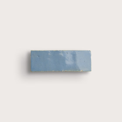 Rectangular blue tile on a light gray background
