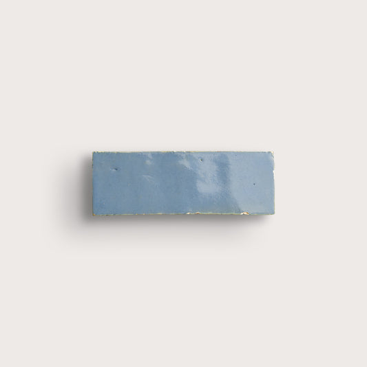 Rectangular blue tile on a light gray background