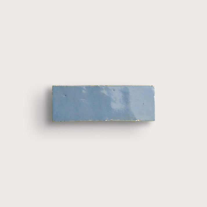 Rectangular blue tile on a light gray background