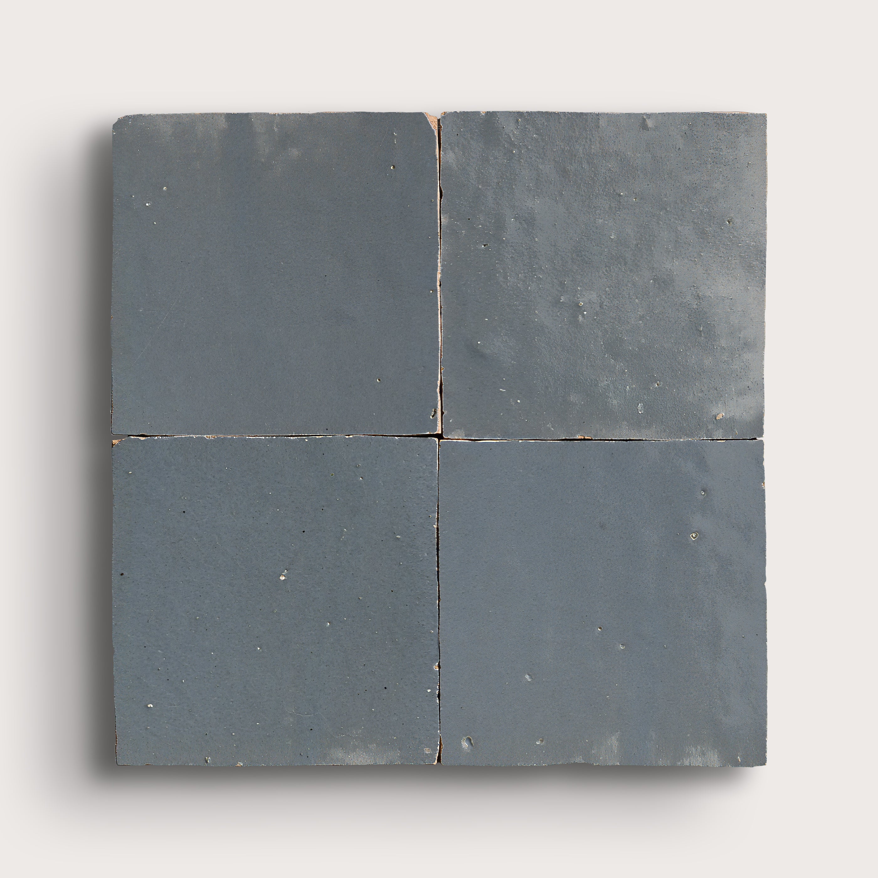 square zellige tile in a grid on a light gray background
