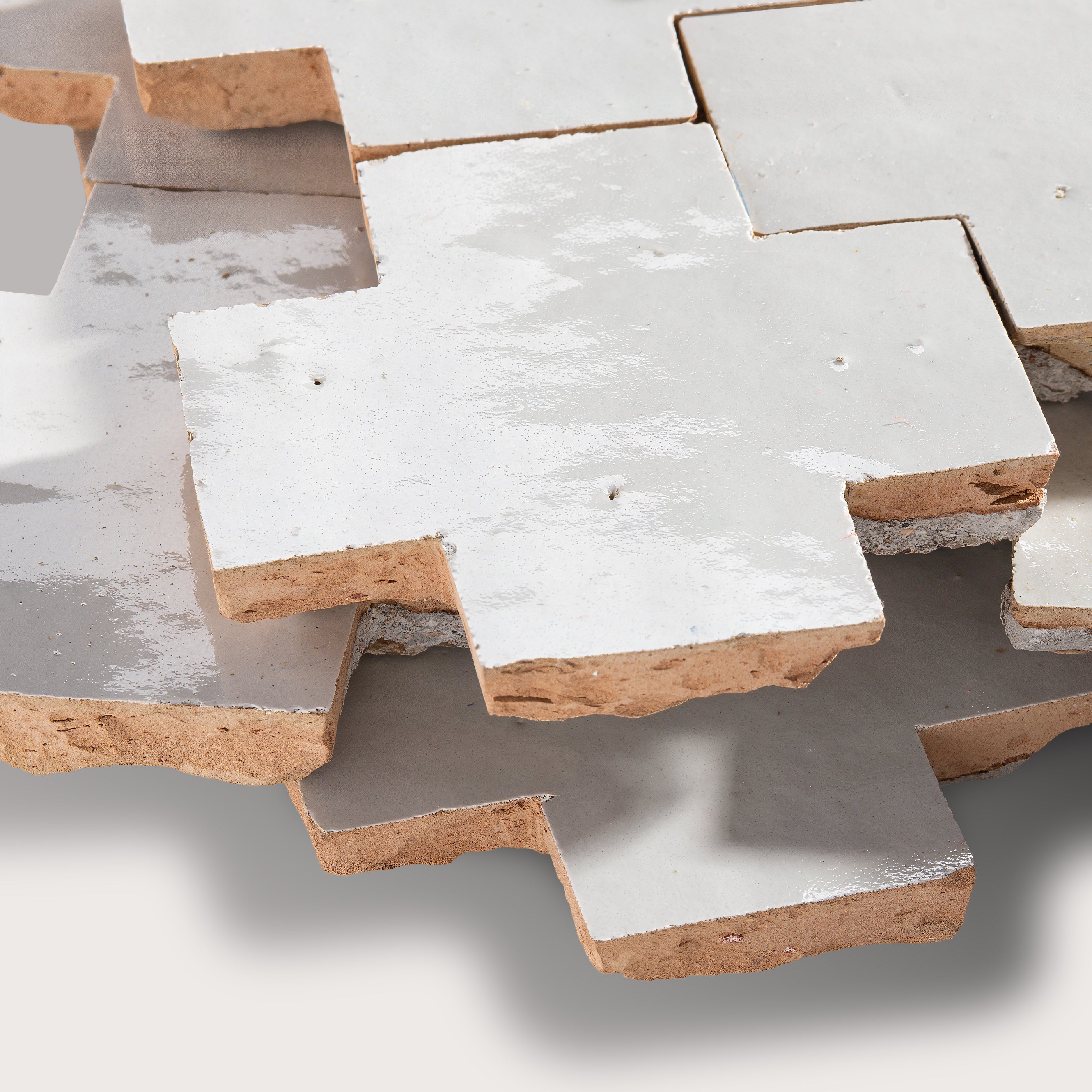 Stack of zellige tiles with a focus on texture and color variation.