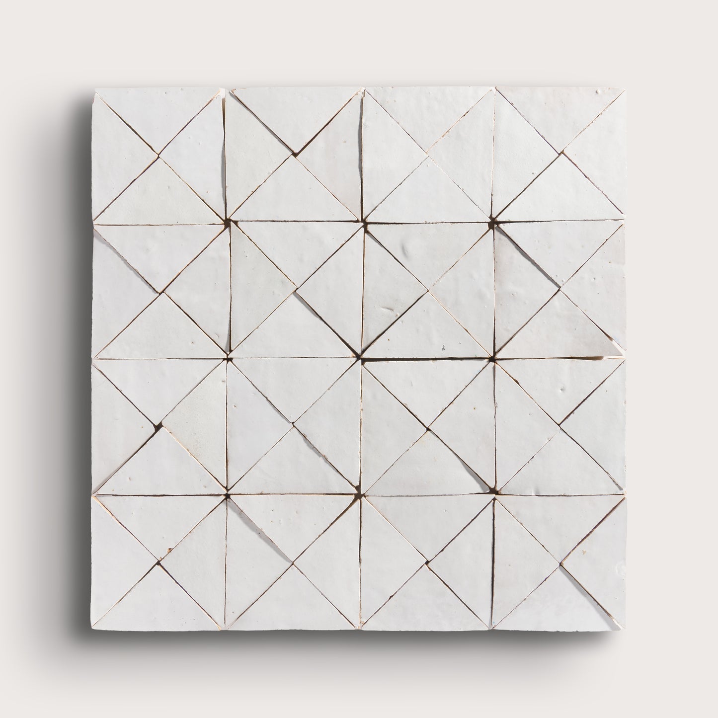 snow white mosaic traingle zellige tile on a light grey background